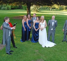 Groom opening champagne with style